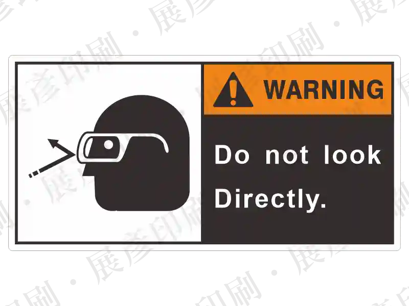 左側為戴護目鏡圖示，右側黑底橘字「WARNING」，文字「Do not look Directly.」。用途：強光/雷射作業請勿直視警示。語系：英文