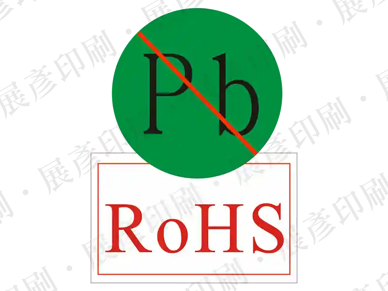 白底，綠色圓形上有黑色「Pb」並打紅色禁止線，下方紅色框線文字「RoHS」。用途：無鉛與RoHS標示。語系：英文